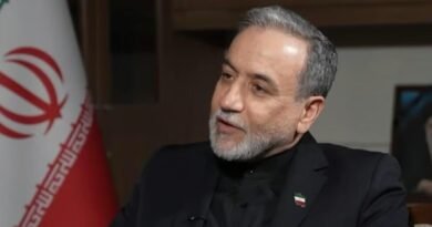 Man speaking with Iranian flag behind